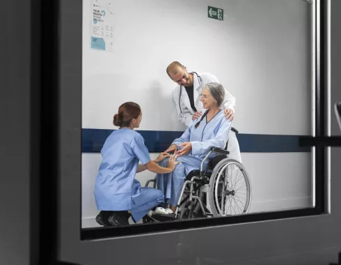 doctor-nurse-helping-patient-wheelchair